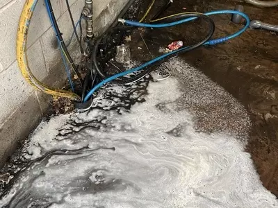 Condition of the wash bay area before installation of the new Nilfisk SH Truck static system. The previous mobile setup had left the area wet and dirty from regular daily fleet cleaning operations, highlighting the need for a cleaner and more permanent in
